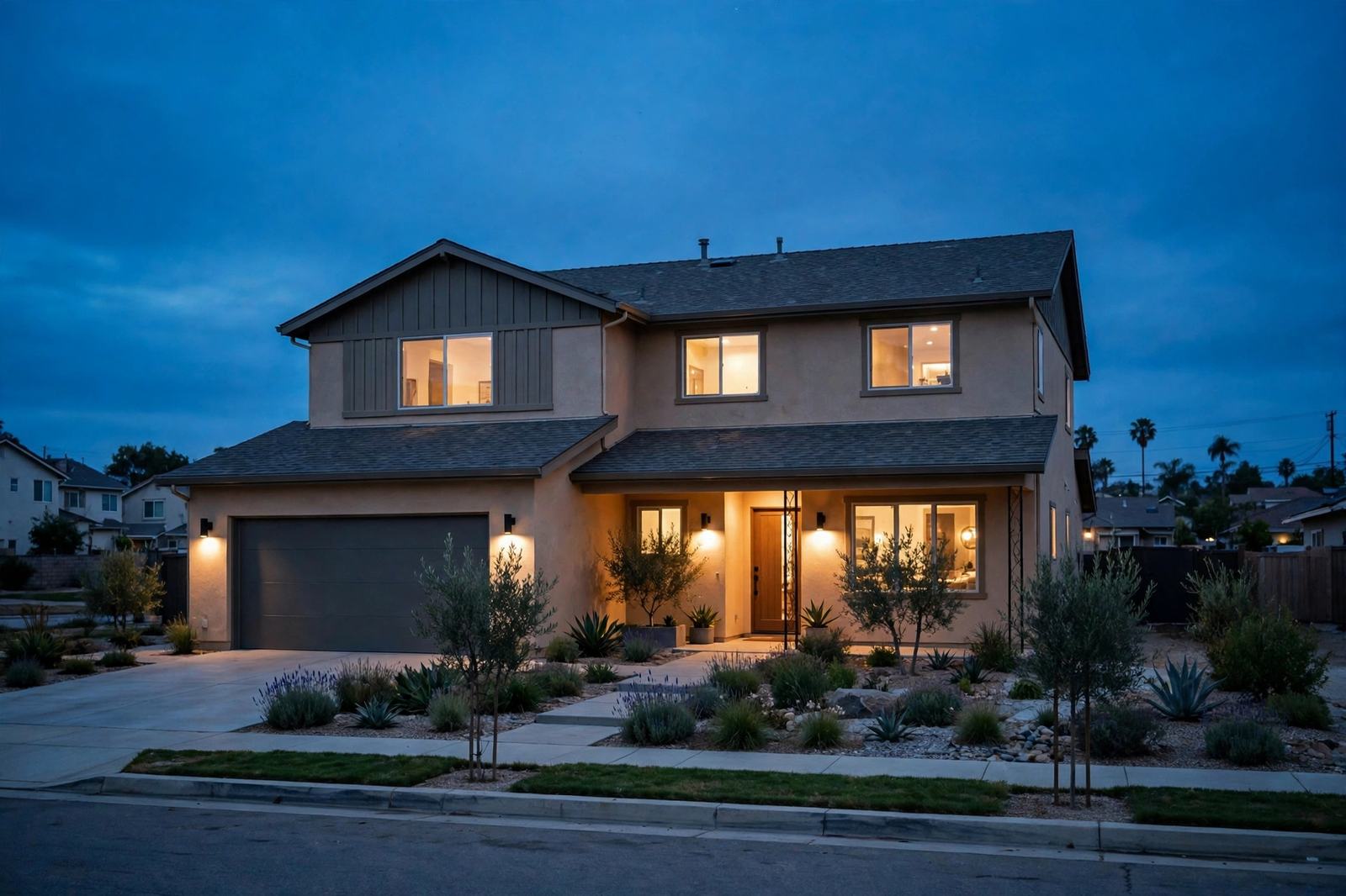 A California home at dusk with warm lights on inside